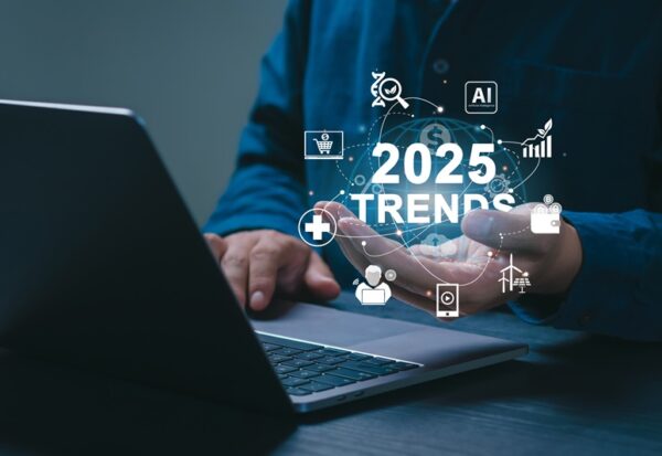 2025 Trends concept. Businessman working on laptop and holding "2025 TRENDS" icons on sgreen. future technological advancements. World business trend online technology. New business opportunities.